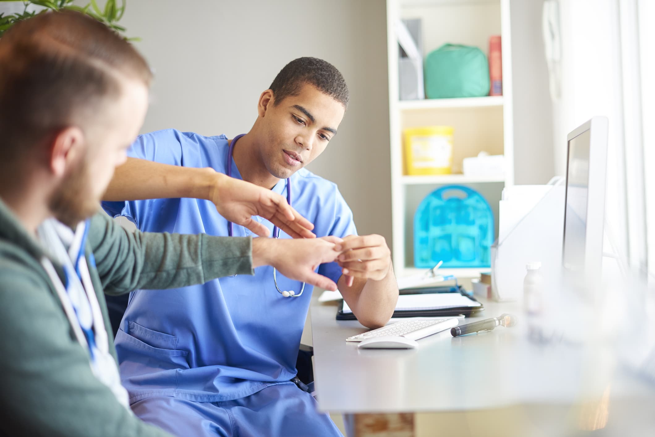 examining patients hand
